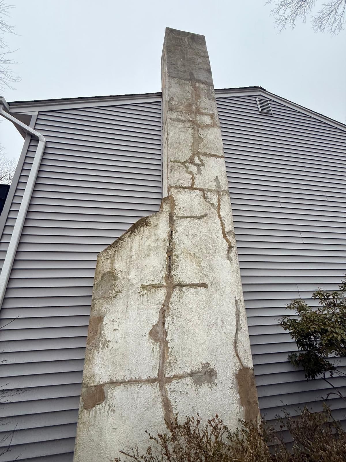 Chimney before restoration showing damage and wear